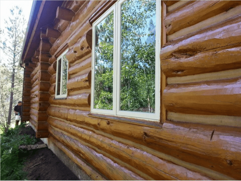 staining wood siding on a log cabin
