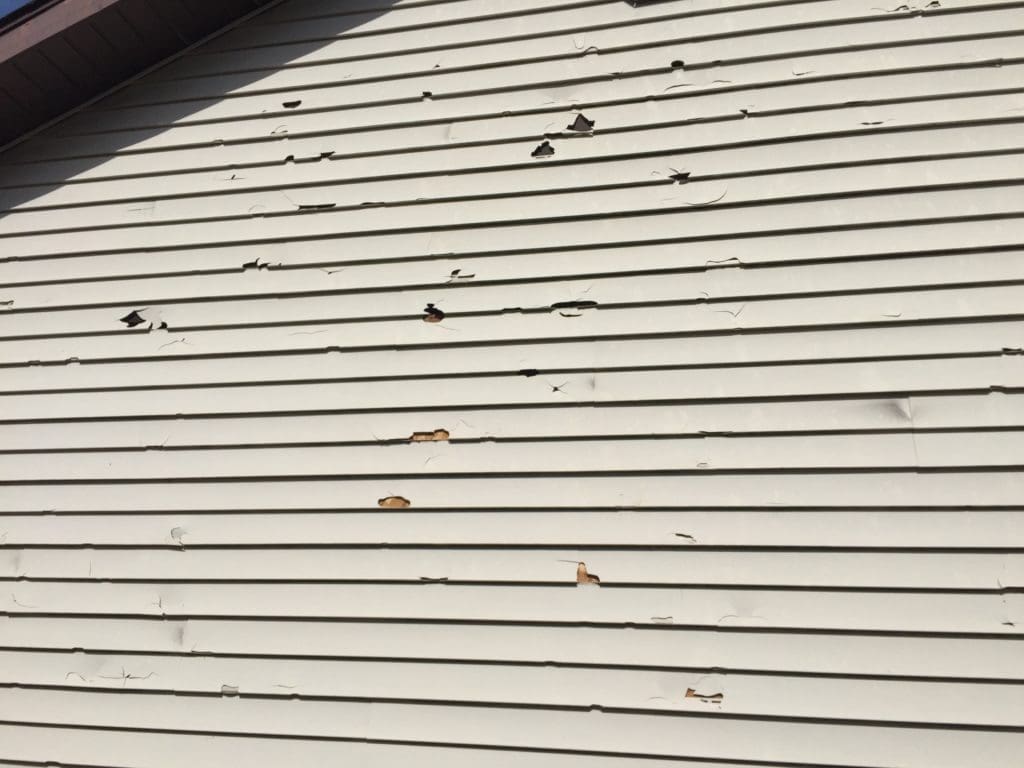 siding damage by a hail storm in Rapid City, SD