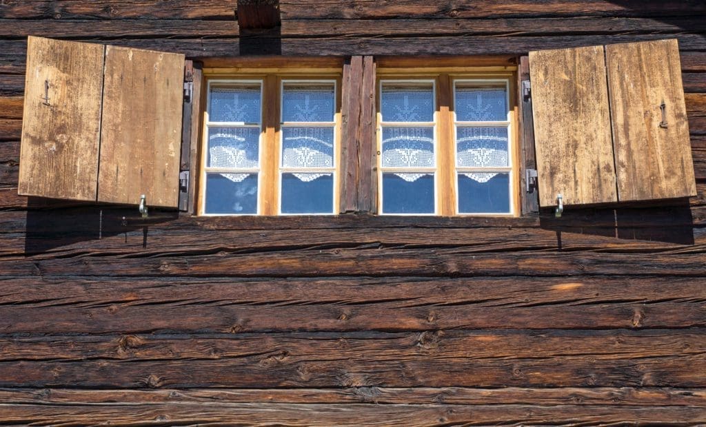 Log cabin with wood siding stained in Hill City, SD